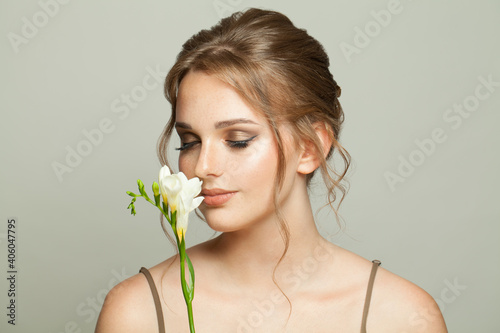 Beautiful woman with smelling white flowers, medicine, skincare and facial treatment concept