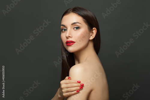 Perfect young woman with clear skin on black background. Skincare and facial treatment concept