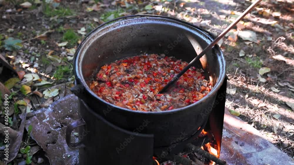 Cooking mashed vegetables at wood fire in the yard traditional food Cooking mashed vegetables at wood fire in the yard traditional food