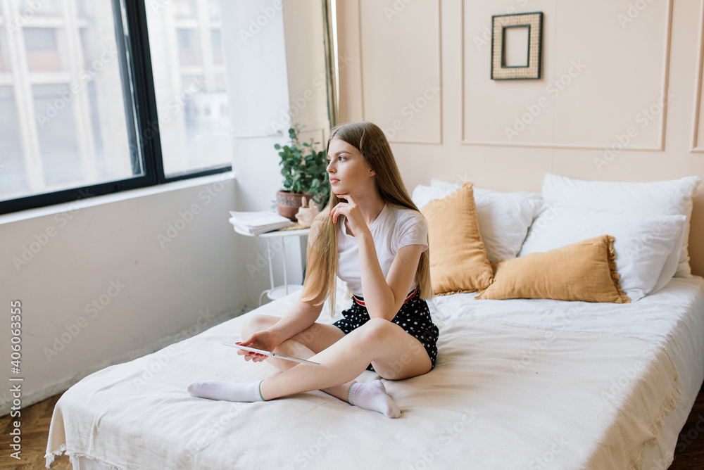A young woman works and study in the home office manager or freelancer at work. Distance education. A young woman works and study in the home office manager or freelancer at work. Distance education.