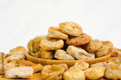 Close up of dried figs. Natural dried figs on white background.  Organic dry fruits. Studio light. Copy space. Health, organic concept. 