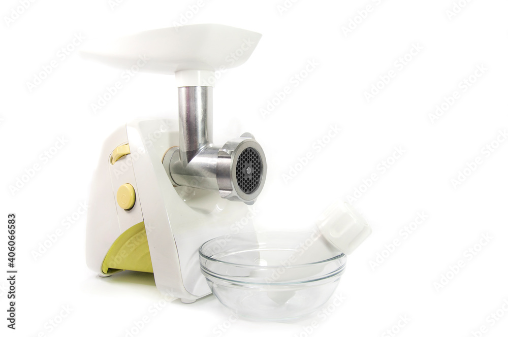 an electric meat grinder next to a transparent deep bowl an electric meat grinder next to a transparent deep bowl