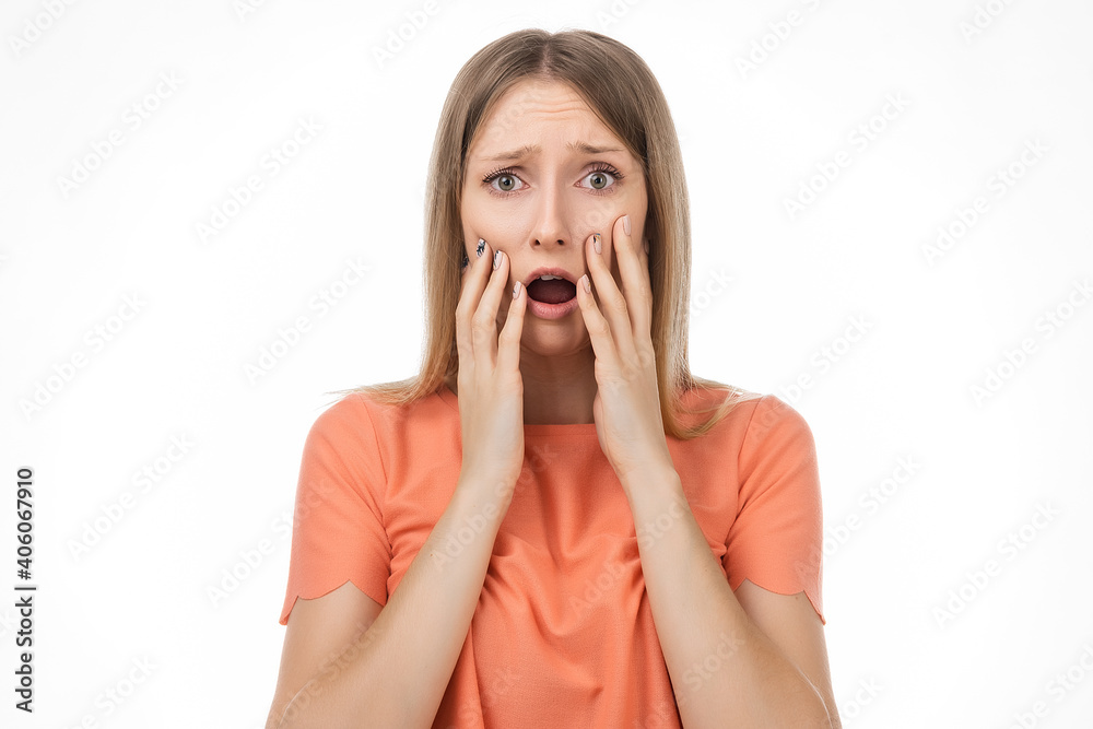 Worried and concerned blond girl is looking with frightened expression. Studio shot, white background Worried and concerned blond girl is looking with frightened expression. Studio shot, white background