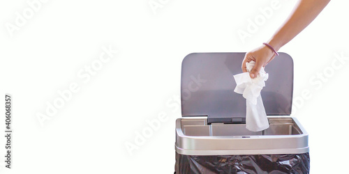 Woman hand throwing a white used crumpled tissue paper handkerchief into a garbage trash bin. Health care and hygiene concept,on white background.