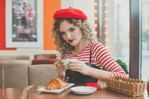 Attractive woman drinking coffee in cafe