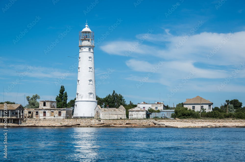 snow-white lighthouse on the cape of the western Crimea Tarkhankut against the blue sky on a clear sunny summer day snow-white lighthouse on the cape of the western Crimea Tarkhankut against the blue sky on a clear sunny summer day