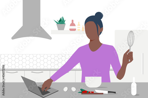 A young black woman looks on laptop and cooking by online video tutorial in her kitchen. Online culinary school. Online courses, e-learning. Eps 10.