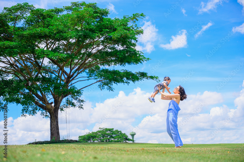 Mother And Baby outdoors. Nature.Portrait of happy loving mother and her baby outdoors