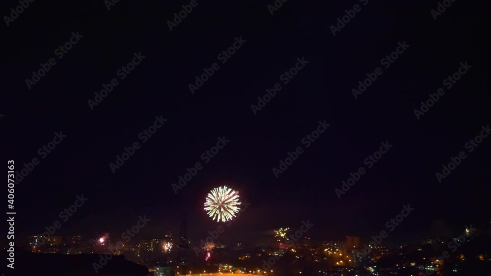 many flashes of fireworks over the night city. general holiday.