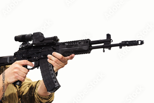 Machine gun in the hands of a man on a white background. Firearms when aiming at a target. Unrecognizable person. Isolate