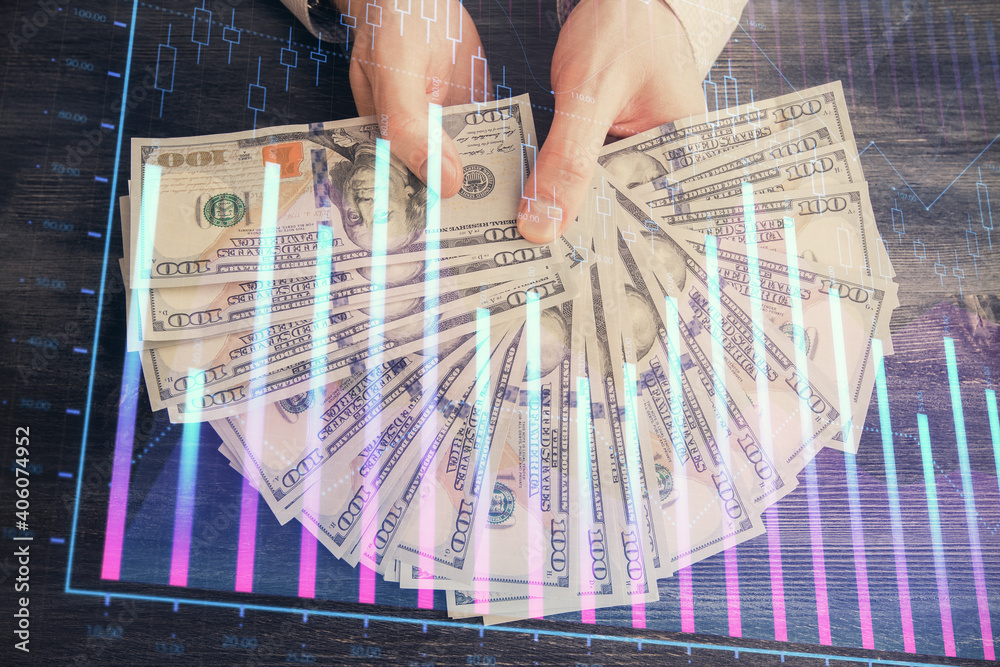 Multi exposure of financial graph drawing hologram and USA dollars bills and man hands. Analysis concept. Multi exposure of financial graph drawing hologram and USA dollars bills and man hands. Analysis concept.