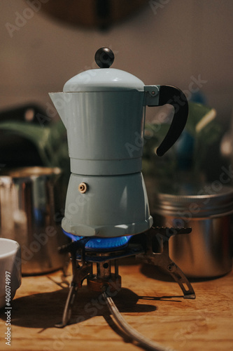 A mocca pot on the stove.Vintage filter and artificial grain effects applied.