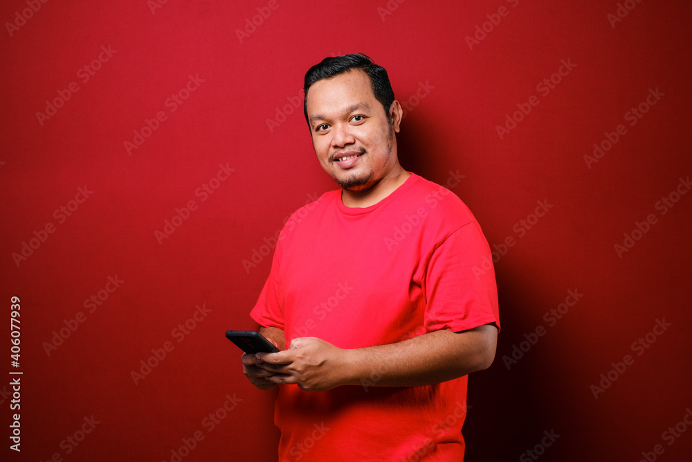 Portrait of Asian man browsing Internet on smartphone