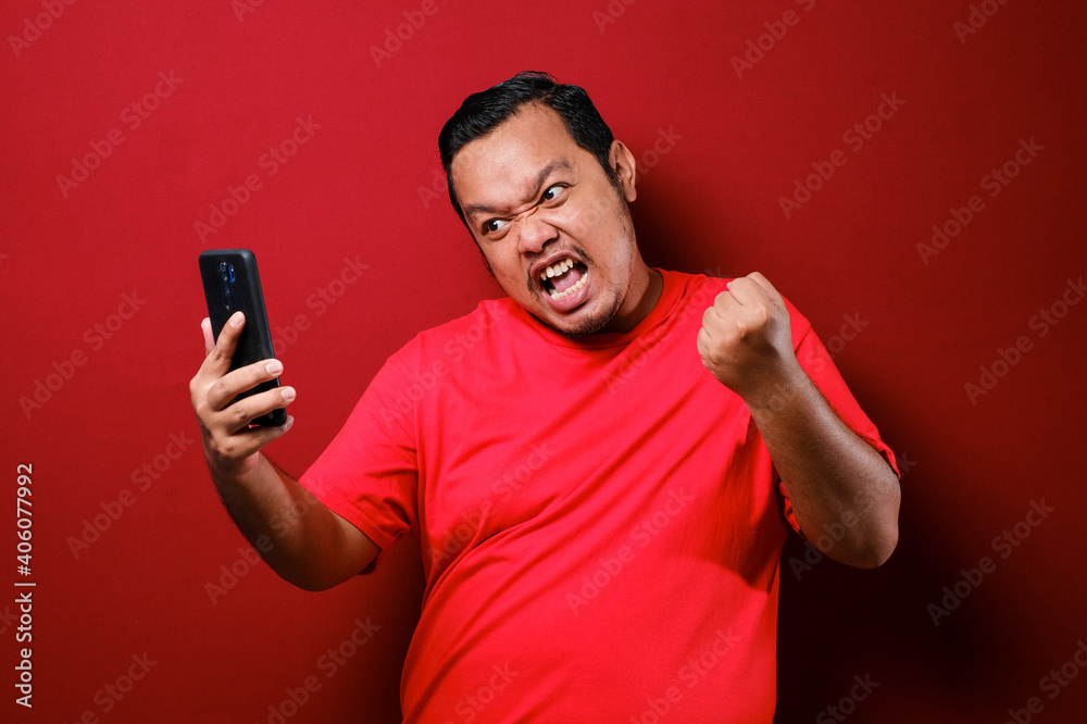 Attractive young Asian man have good news on his phone Attractive young Asian man have good news on his phone