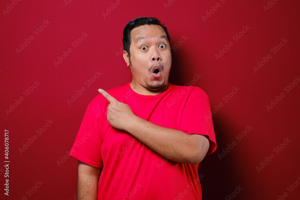 Asian Man Smile to camera while Presenting Something on His Side with Copy Space Asian Man Smile to camera while Presenting Something on His Side with Copy Space