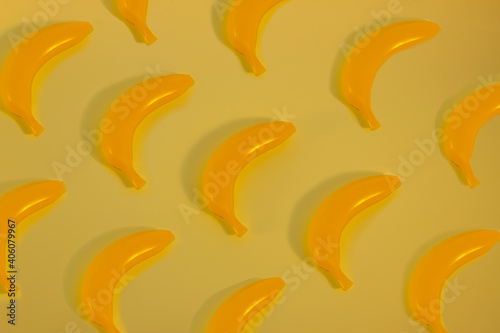 Summer pattern of bright light with bananas on a bed-yellow background