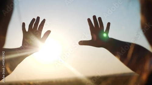 hands in the sun. mom and daughter hands reach out to the sun silhouette sunlight. happy family kid dream concept. mom and daughter dream of god religion sunset concept photo