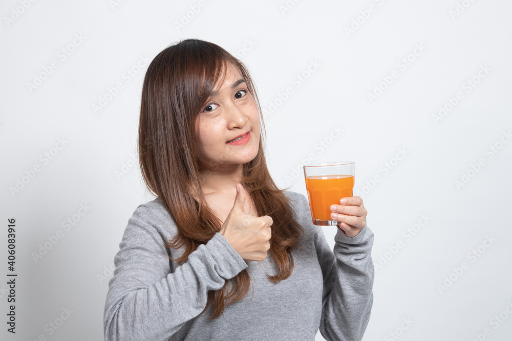 Young Asian woman thumbs up drink orange juice. Young Asian woman thumbs up drink orange juice.
