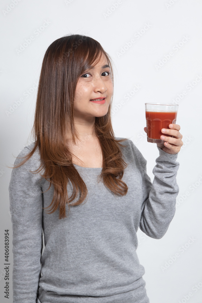 Young Asian woman drink tomato juice. Young Asian woman drink tomato juice.