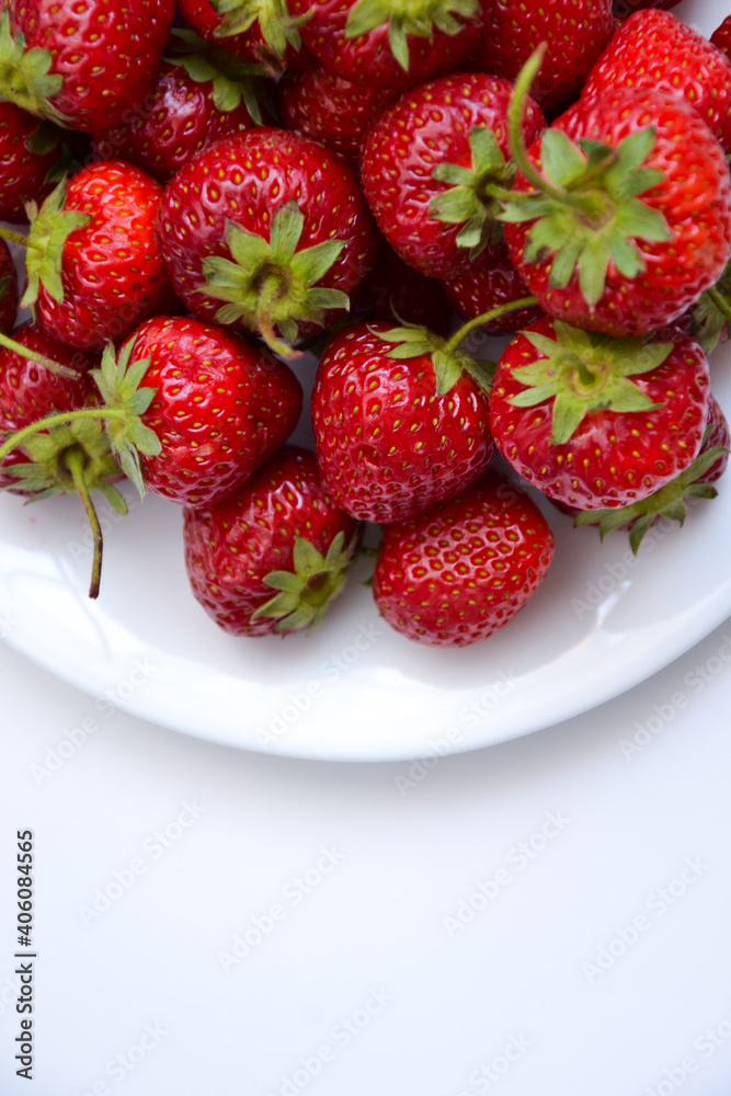 Strawberries on white plate. Freshly picked strawberry. Organic berries on white background. Village garden harvest. Strawberries on white plate. Freshly picked strawberry. Organic berries on white background. Village garden harvest.