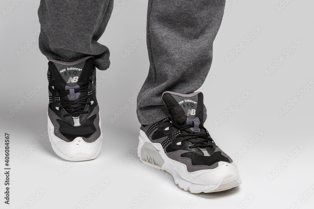 Kiev, Ukraine - January 03, 2021: Men's casual sneakers from the New Balance  brand on a light background. Man in sweatpants and sneakers on gray  background Stock Photo | Adobe Stock