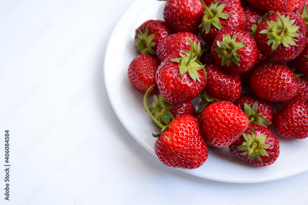 Strawberries on white plate. Freshly picked strawberry. Organic berries on white background. Village garden harvest. Strawberries on white plate. Freshly picked strawberry. Organic berries on white background. Village garden harvest.