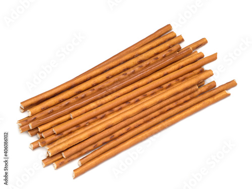 Sweet straws. Dry baked goods in the form of thin sticks. White background.