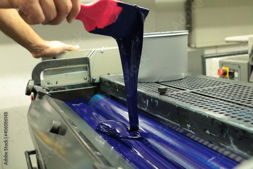 The blue color dye put into the dye chamber of the printing press. selective focus is used. © Emrah