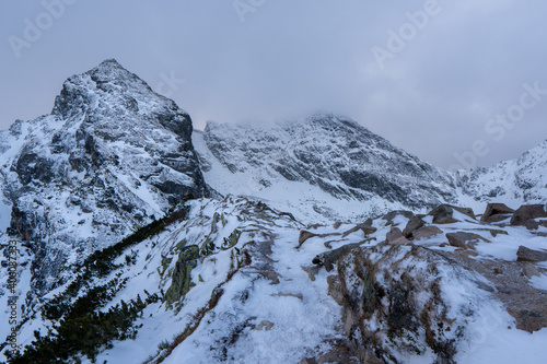 Fototapeta Naklejka Na Ścianę i Meble -  Winter mountains panoramic view with clouds. Tatras mountain in poland europe. Koscielec