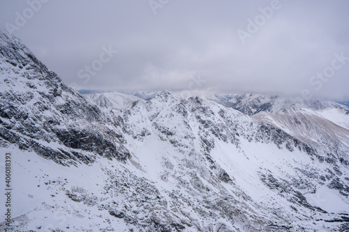 Fototapeta Naklejka Na Ścianę i Meble -  Winter mountains panoramic view with clouds. Tatras mountain in poland europe. Koscielec