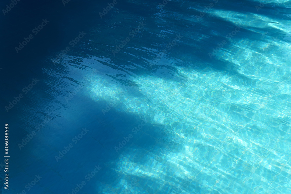 Blue swimming pool water with dark shadow texture