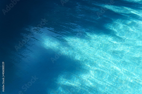 Blue swimming pool water with dark shadow texture