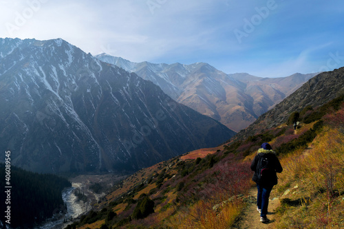Fototapeta Naklejka Na Ścianę i Meble -  Young woman hiking in Ala Archa  National Park, Kirgyzstan