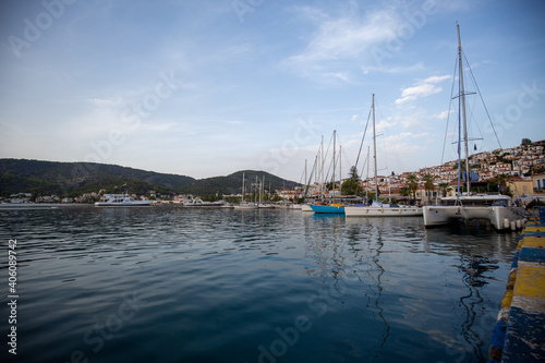 boats in the harbor beautiful sunset over the sea of Poros, Greece © Dimitar