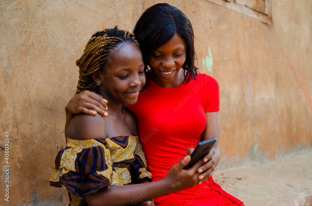 happy sisters having fun with mobile smart phone outdoor - new normal tech concept with sisters together happy sisters having fun with mobile smart phone outdoor - new normal tech concept with sisters together