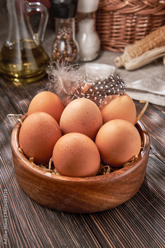 Brown chicken eggs close-up in a wooden bowl, organic protein of natural origin, free space for text. Brown chicken eggs close-up in a wooden bowl, organic protein of natural origin, free space for text.
