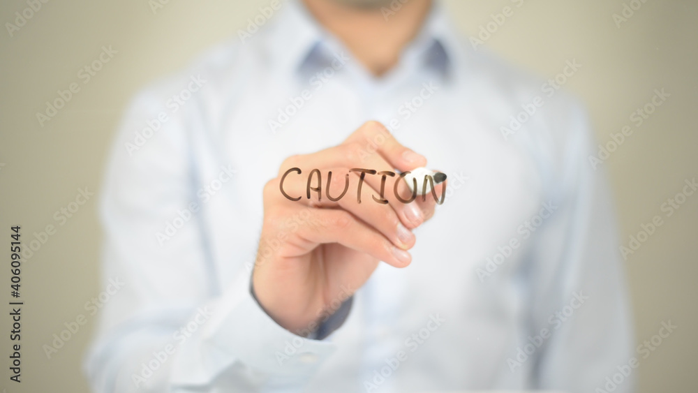 Caution, Man writing on transparent screen Caution, Man writing on transparent screen