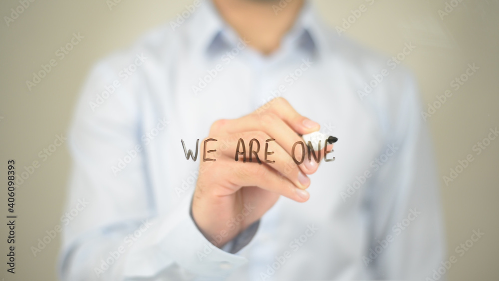 We are One, Man Writing on Transparent Screen We are One, Man Writing on Transparent Screen