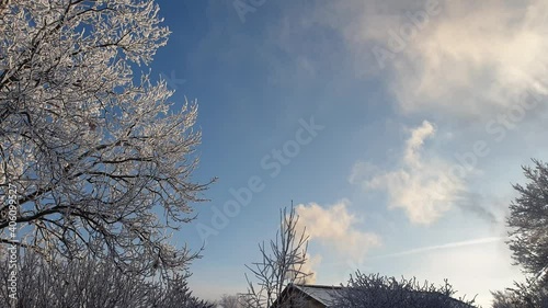 stove heating of a country house, smoke from a cottage chimney on a Sunny winter day, heating with wood and coal in winter