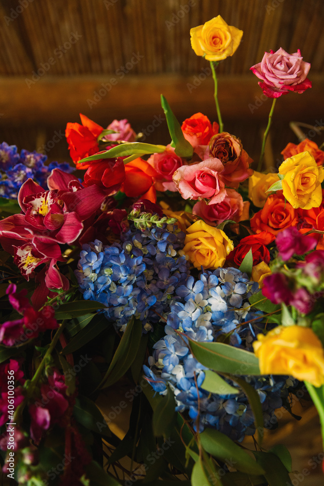 Orange, pink, blue flower arrangement at wedding