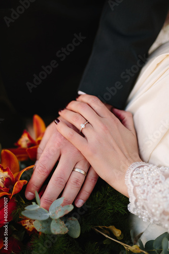 Bride and groom hands with wedding rings