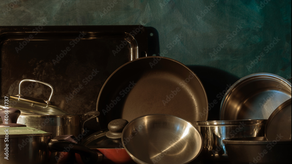 Pots and pans stacked on a kitchen shelf Pots and pans stacked on a kitchen shelf