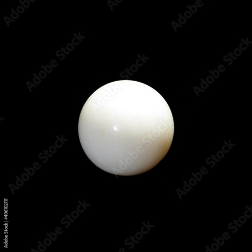 white nephrite ball on black background 