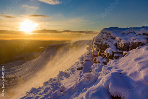 Beautiful sunrise over a cold., snow covered mountain