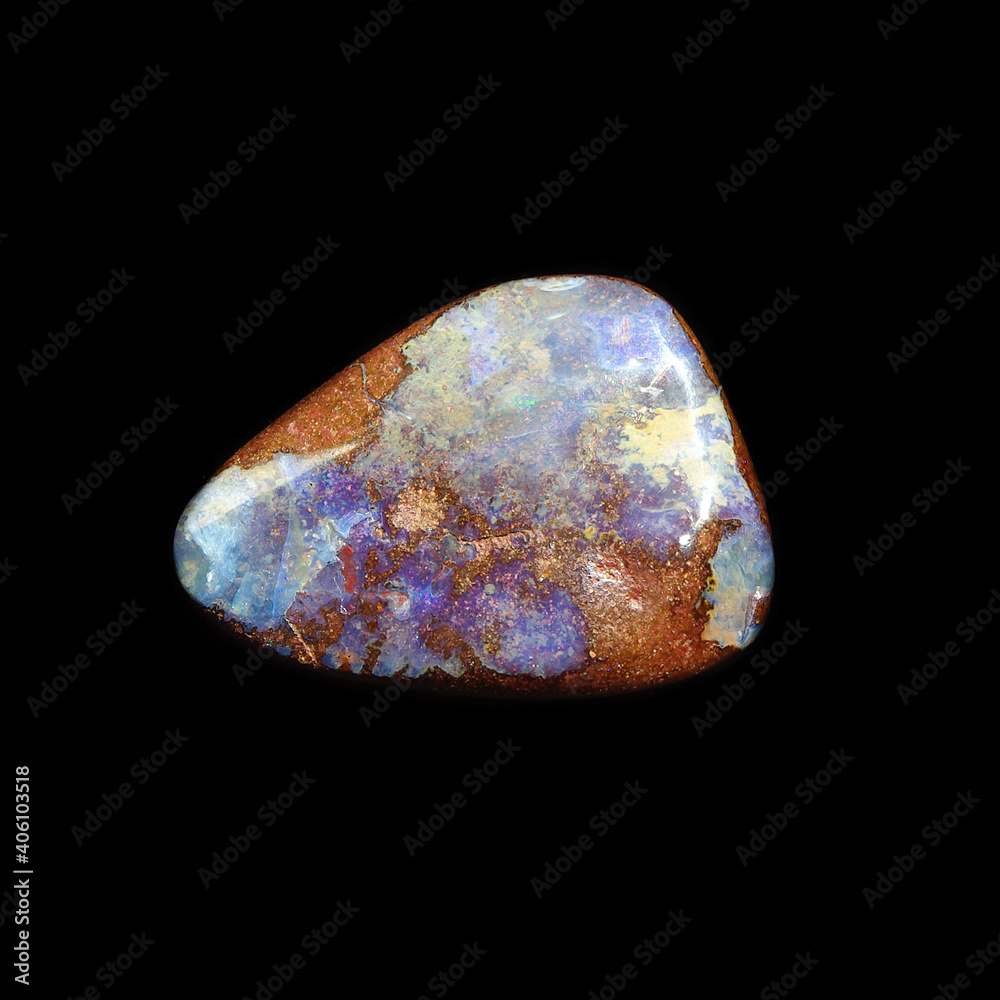 Tumbling opal stone on black background Tumbling opal stone on black background