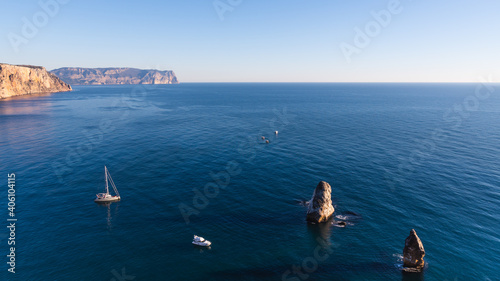 Many ships and boats on the water of Black sea in the Bay of Sevastopol with rocks and mountains