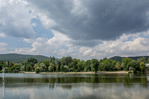 Beautiful peaceful nature, trees and plants on a lake, summertime season, reflection in the water, Zagorka lake, Stara Zagora, Bulgaria