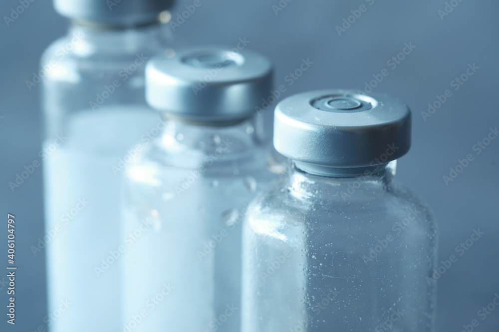 Close up of coronavirus vaccine and syringe on black background Close up of coronavirus vaccine and syringe on black background