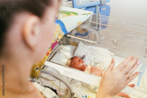 Fotografie Portrait of Premature newborn baby sleeping in incubator , ICu.