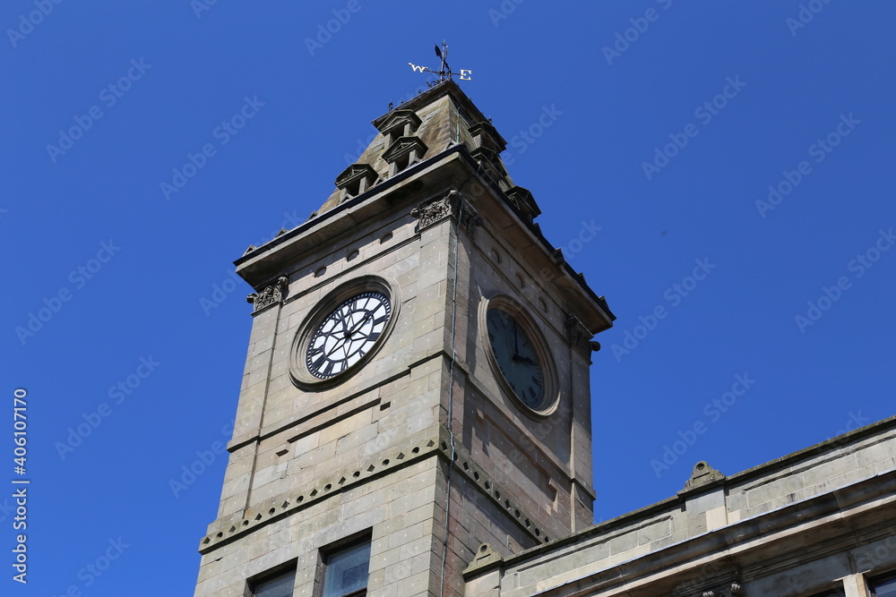 A Town Hall Clock and tower in Welshpool,  Powys, Wales, set against a blue sky.
